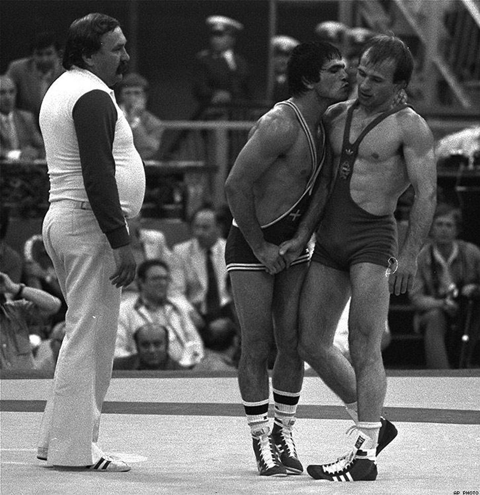 1980: Greece's Stilianos Migiakis, center, gives Hungary's Istvan Toth a kiss and hug after he beat Toth for the gold in Moscow.