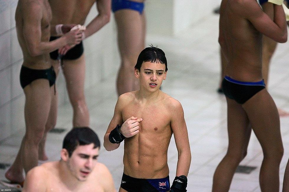 2008: Britain's 14-year-old Thomas Daley before performing with his partner Blake Aldridge (background) in the men's 10-meter synchronized final in the National Aquatics Center at the Beijing Olympics.