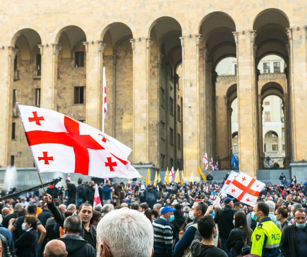 2020 Tbilisi Republic of Georgia Post election protest large crowd with flags in front of Parliament building