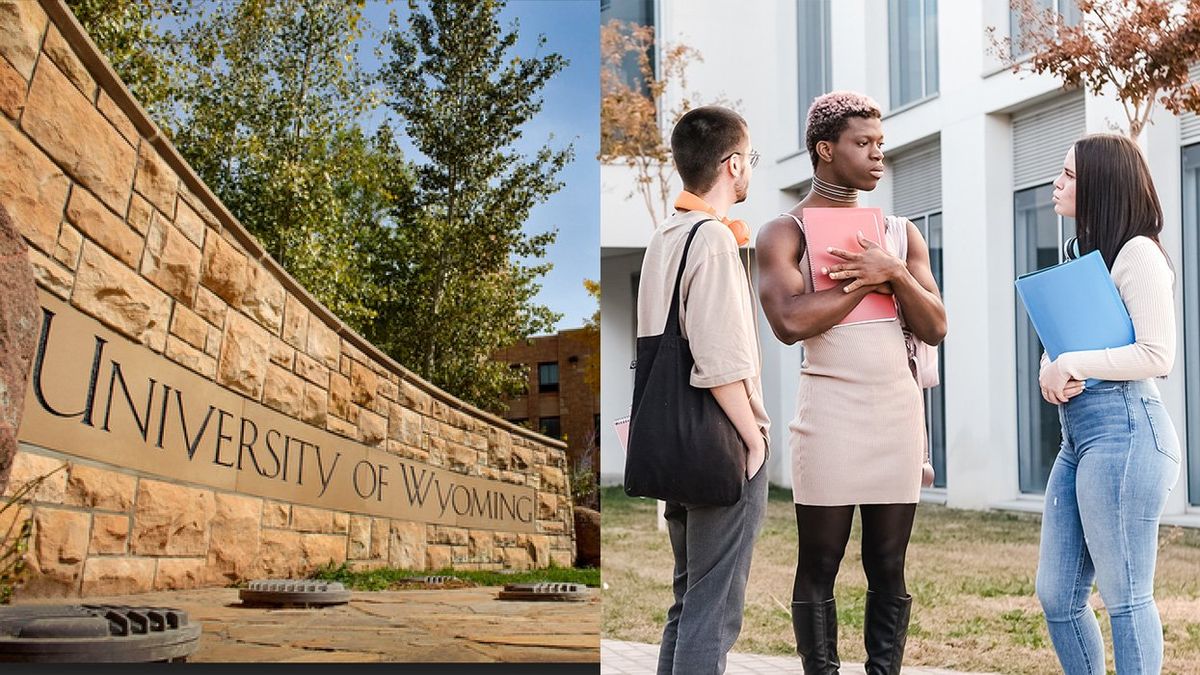 a brick and concrete sign with university of wyoming etched on it and a group of college students talking on campus