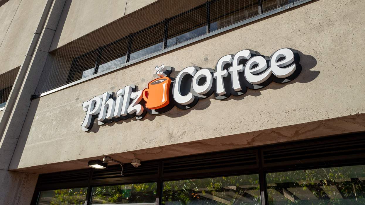 A building displays a white logo with an orange coffee mug that reads "Philz Coffee."