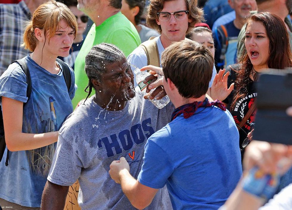 A counter demonstrator is splashed with water after he was hit by pepper spray from an white nationalist demonstrator