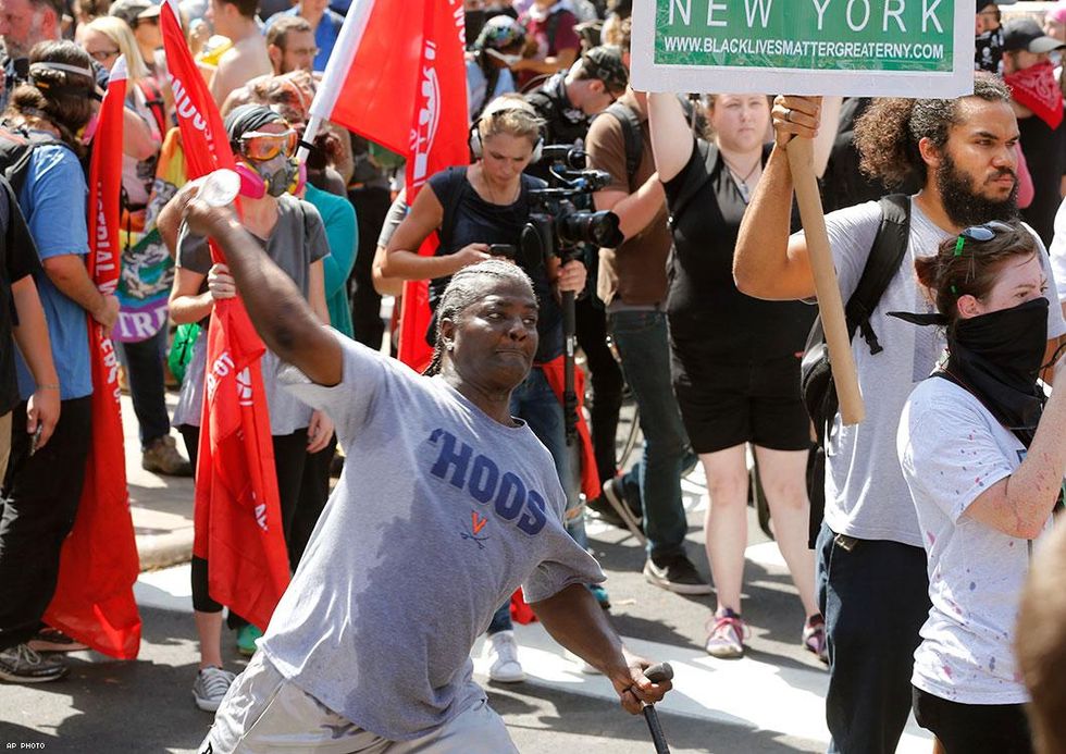A counter demonstrator throws a water bottle at an white nationalist demonstrator
