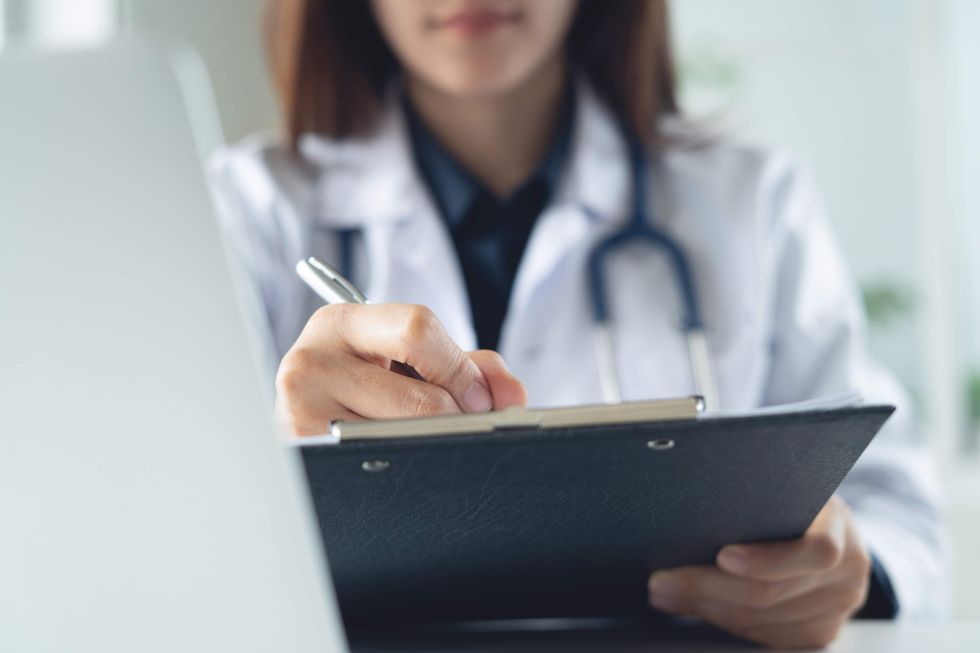 A doctor holding a clipboard.