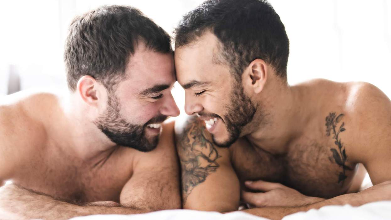 A gay couple in bed together.