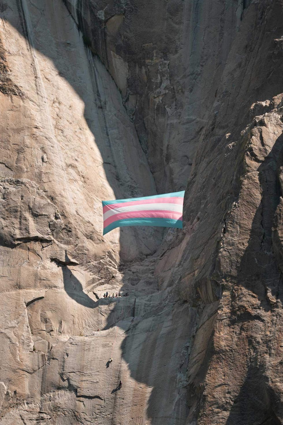 a giant transgender pride flag hangs on el capitan summit in yosemite national park