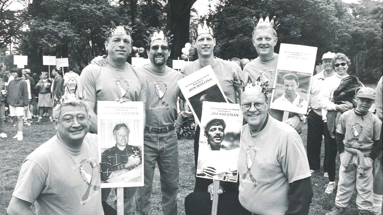 A group of men hold photos of friends and lovers lost to HIV at the 1999 AIDS Walk
