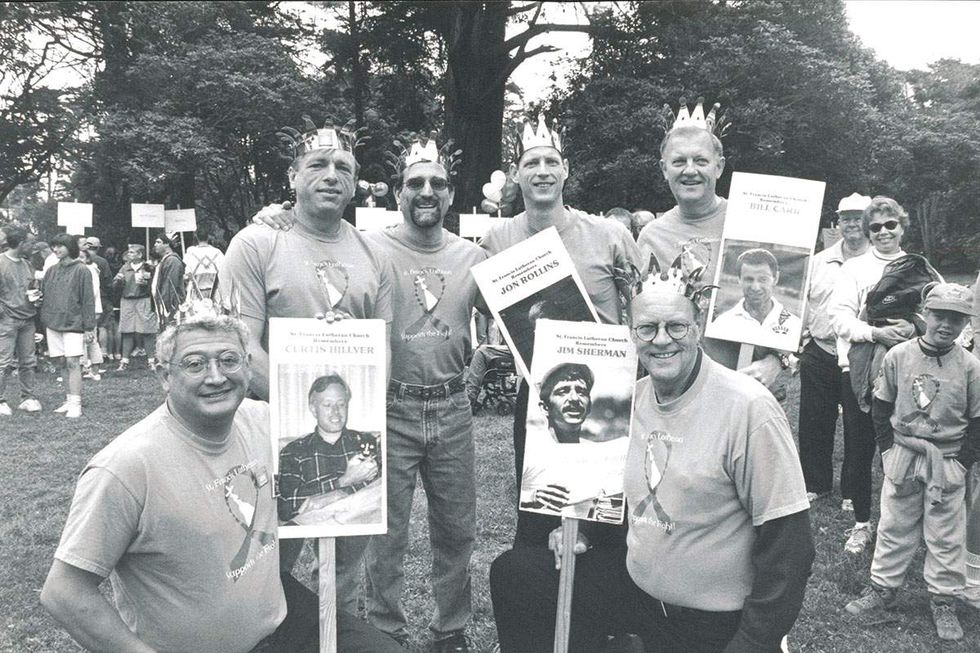 A group of men hold photos of friends and lovers lost to HIV at the 1999 AIDS Walk