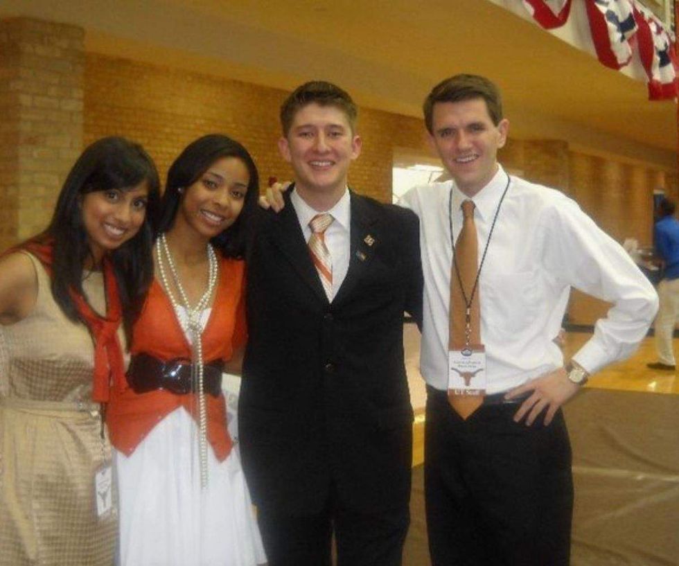a group of people posing for a photo at the UT Austin