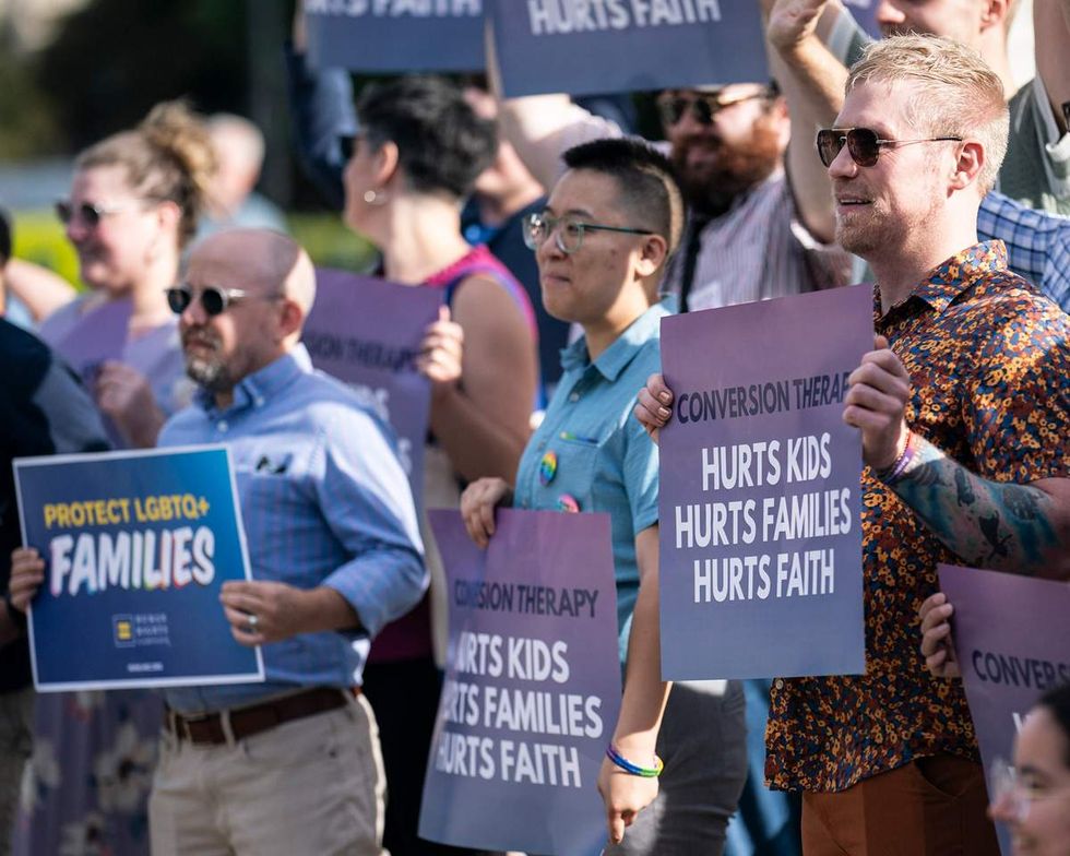 a group of people protest conversion therapy