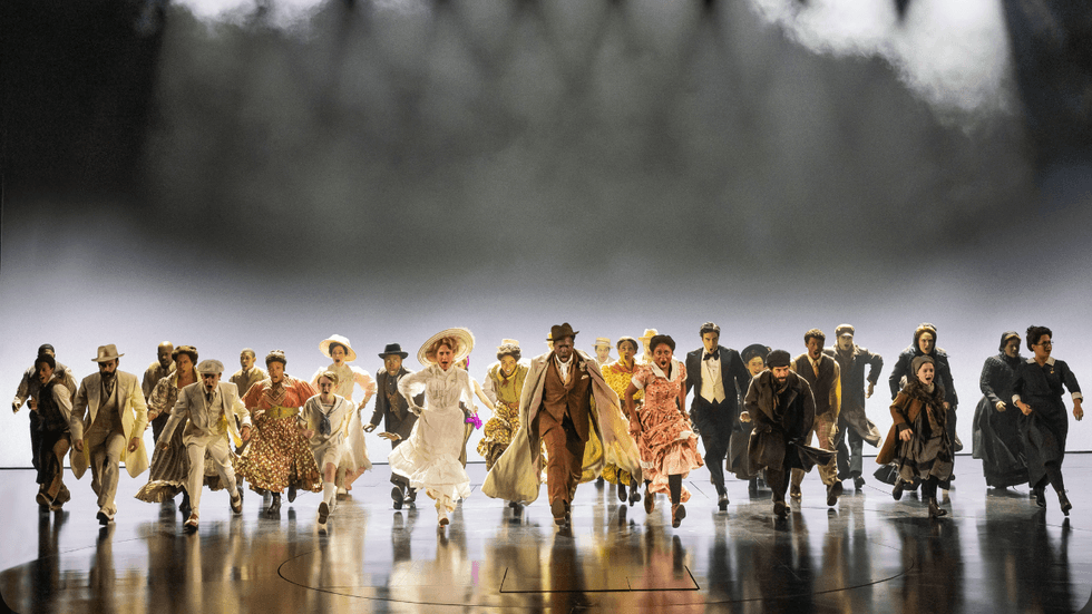 A group of people running towards the front of the stage