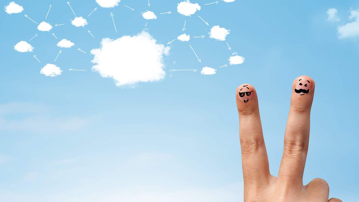 A hand making a piece sign under an image of a cloud