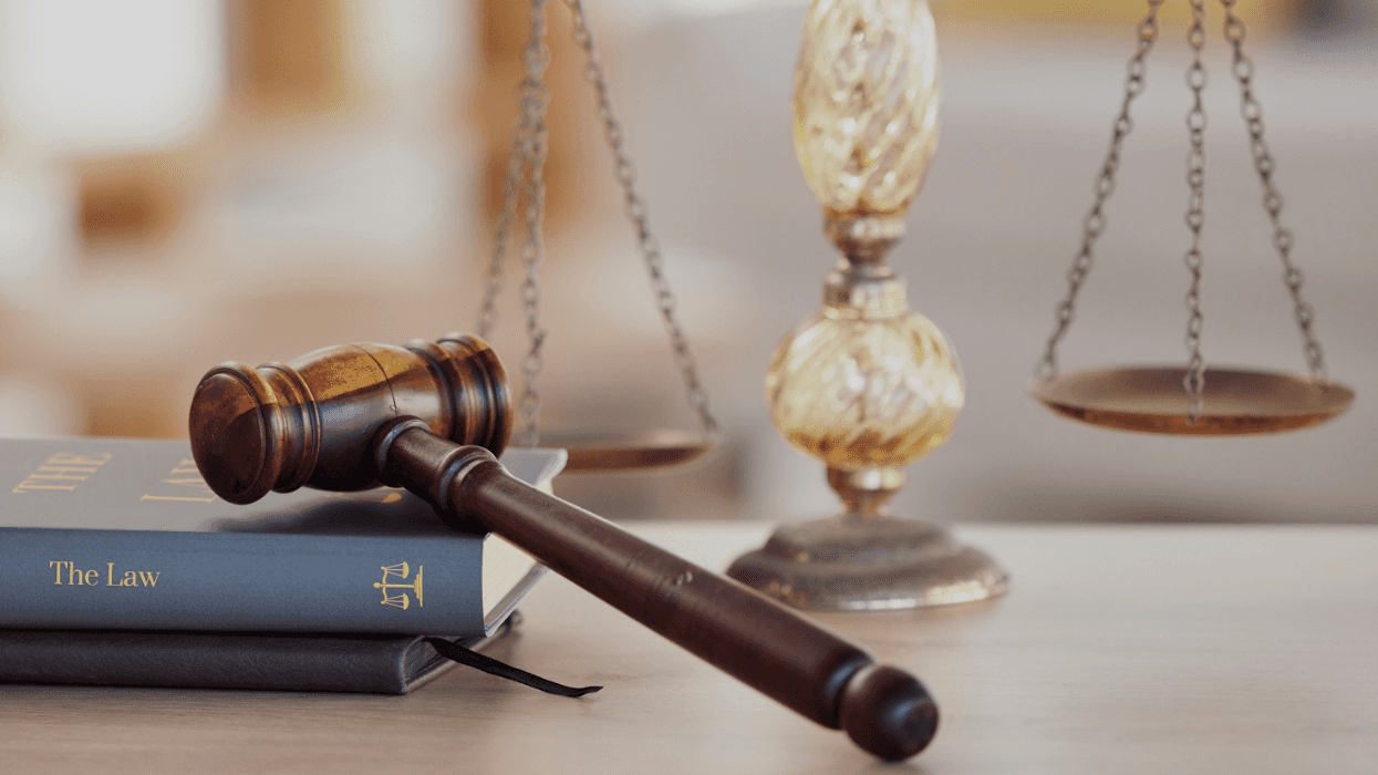 A judge’s gavel resting on law books with scales of justice in the background