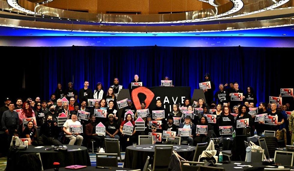a large group of people holding hiv awareness signs