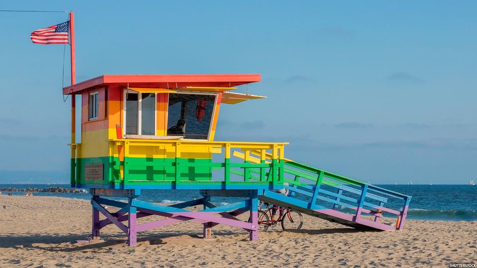 A lifeguard tower painted in rainbow colors