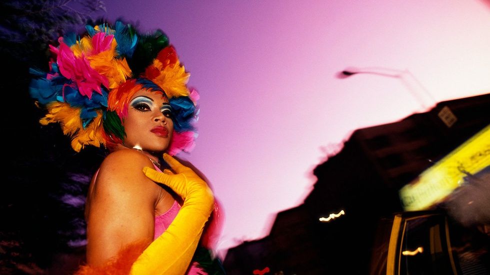 A man dons a feather headdress for the 2001 Wigstock, and annual drag festival held in Manhattan.