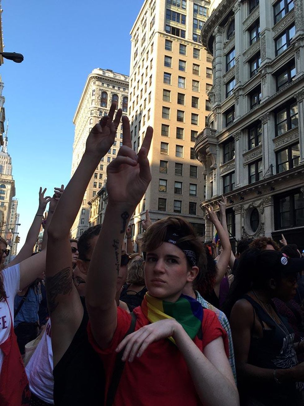 A marcher participates in the moment of silence for victims of the Pulse nightclub shooting in Orlando.