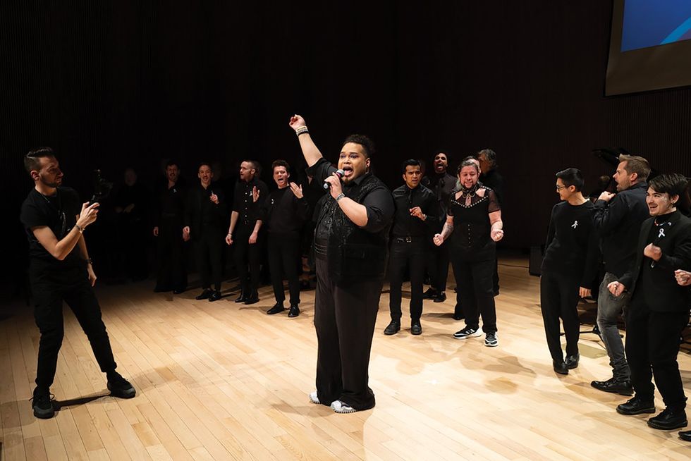 A member of NYC Gay Mens Chorus sing on stage