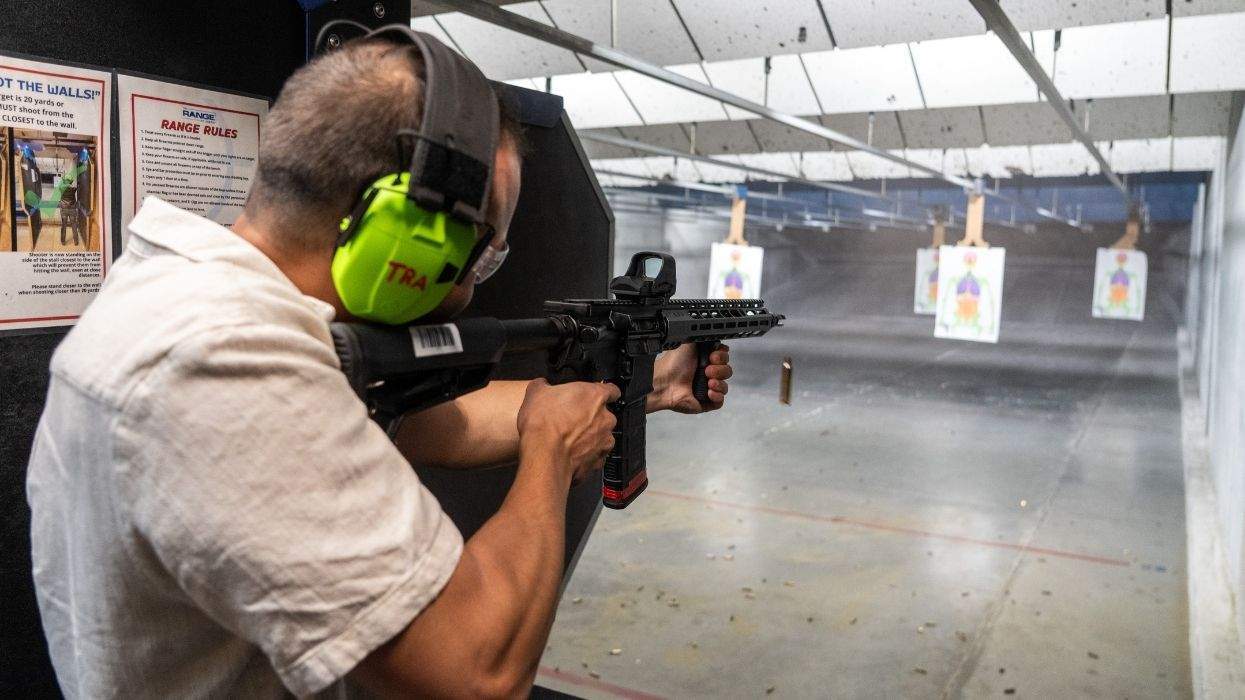 a person at a gun range with a long gun