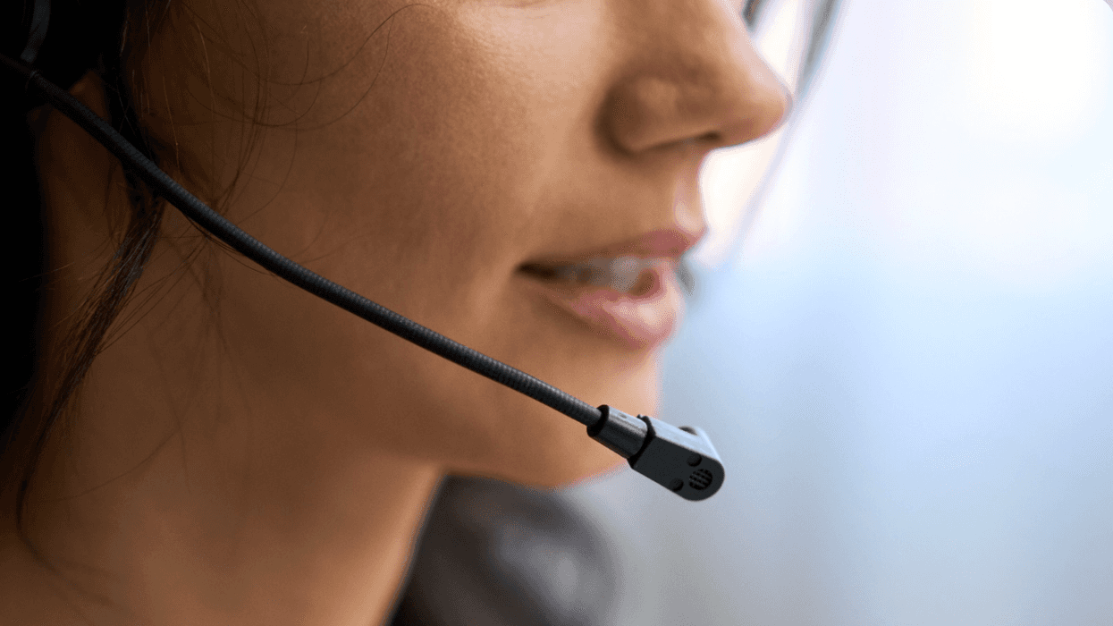 A person speaks into a call center headset.