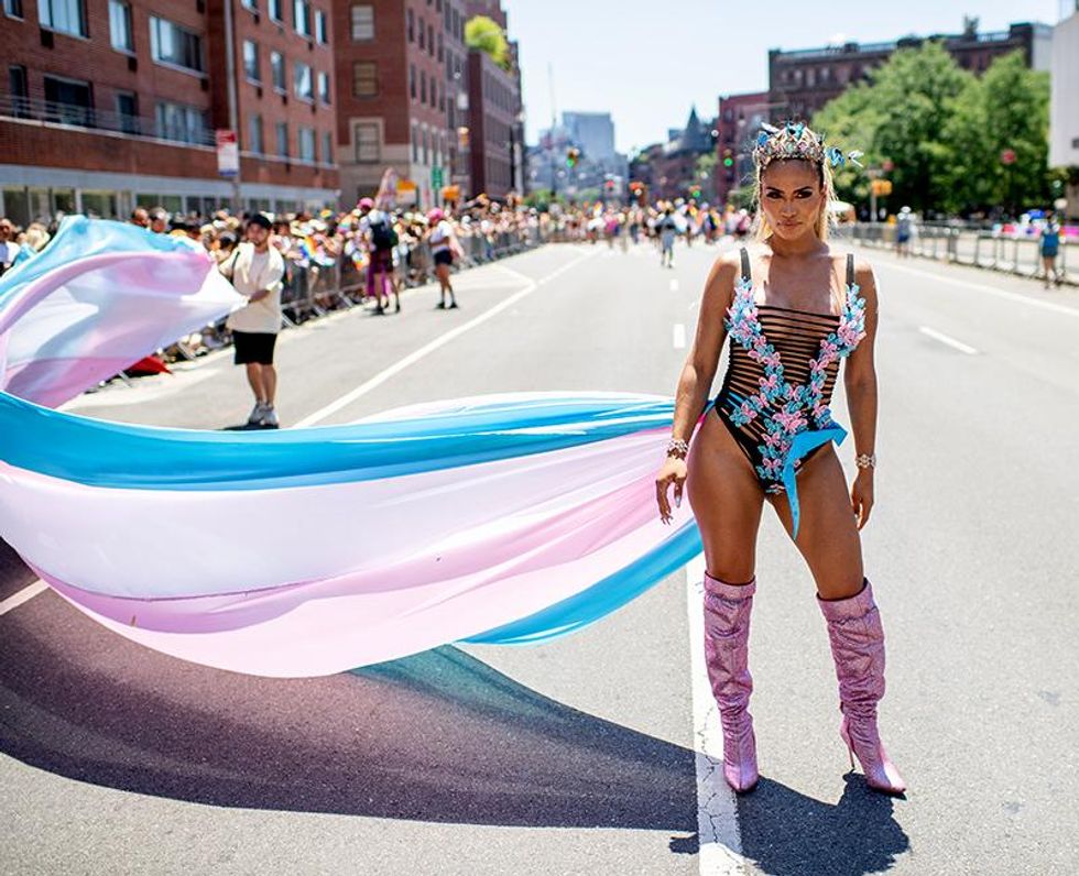 A person walks the New York City Pride Parade on June 26, 2022 wearing colors of the transgender flag