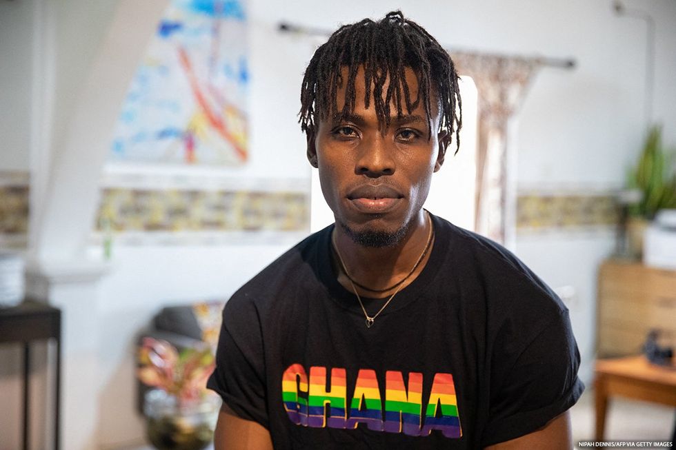 A person wearing a Ghana shirt looking at the camera