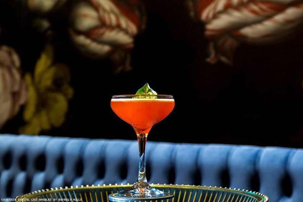 a red cocktail in martini glass