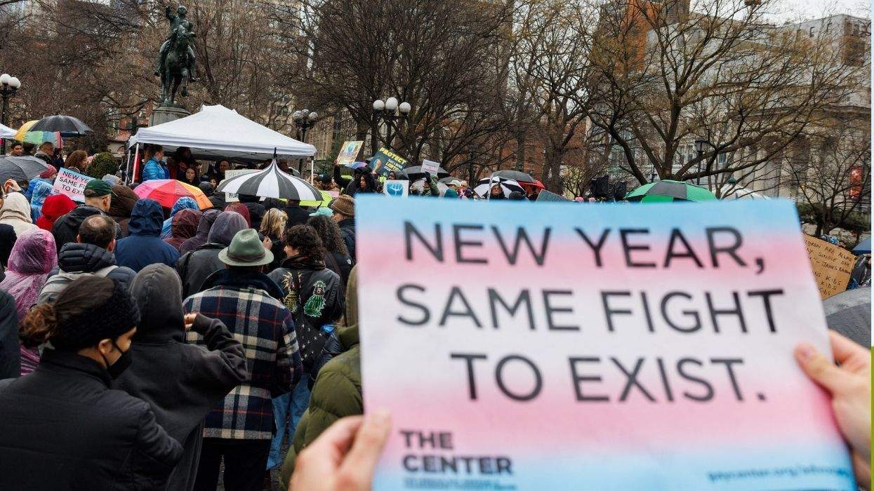 a sign at a protest reading new year same fight to exist