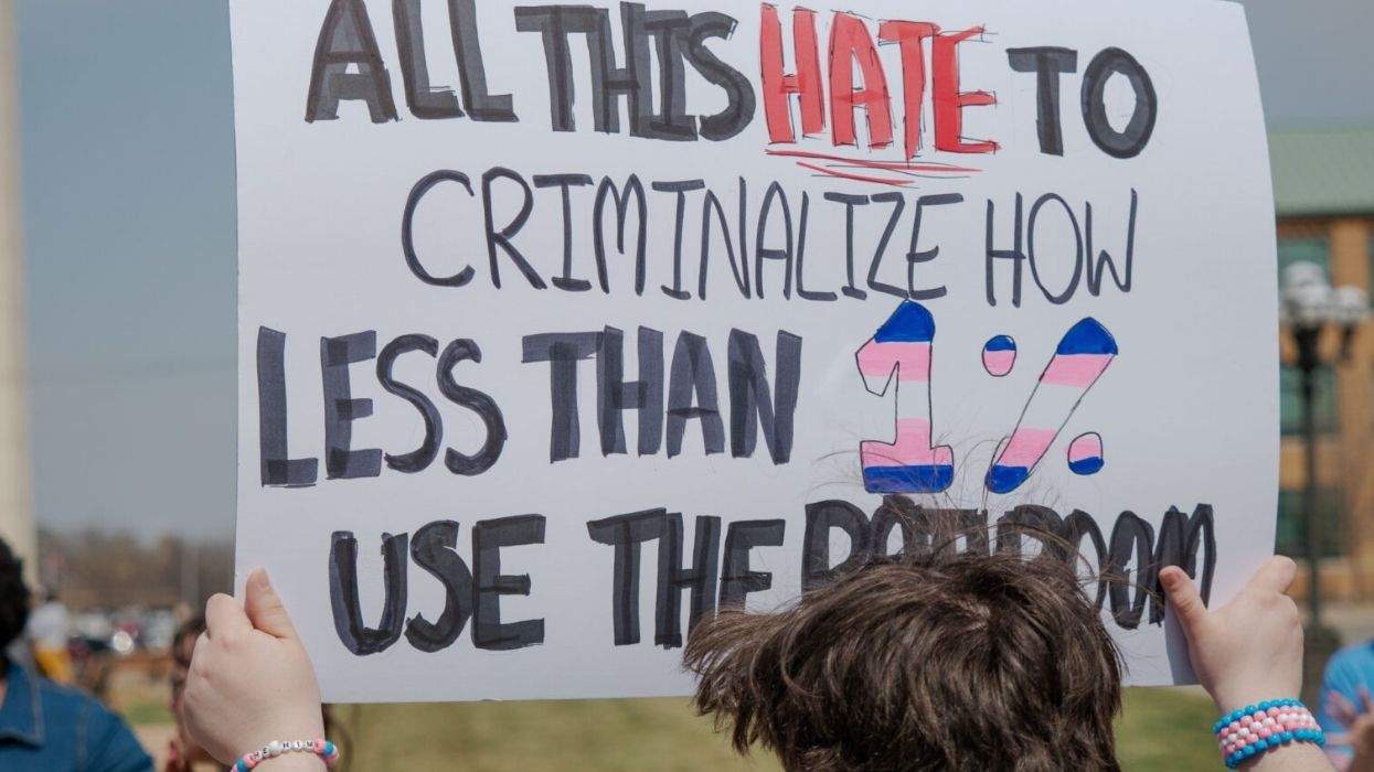 a sign reading all this hate to criminalize how less than 1% use the bathroom