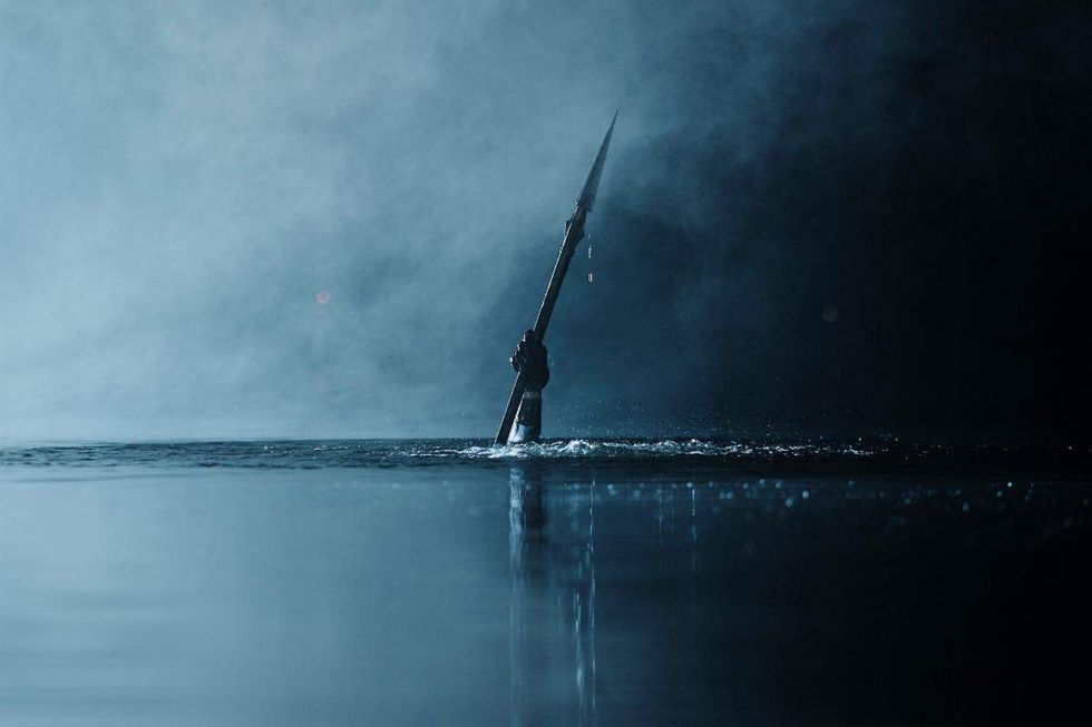 A spear comes out of the water in still from 'Teenage Sex & Death at Camp Miasma'