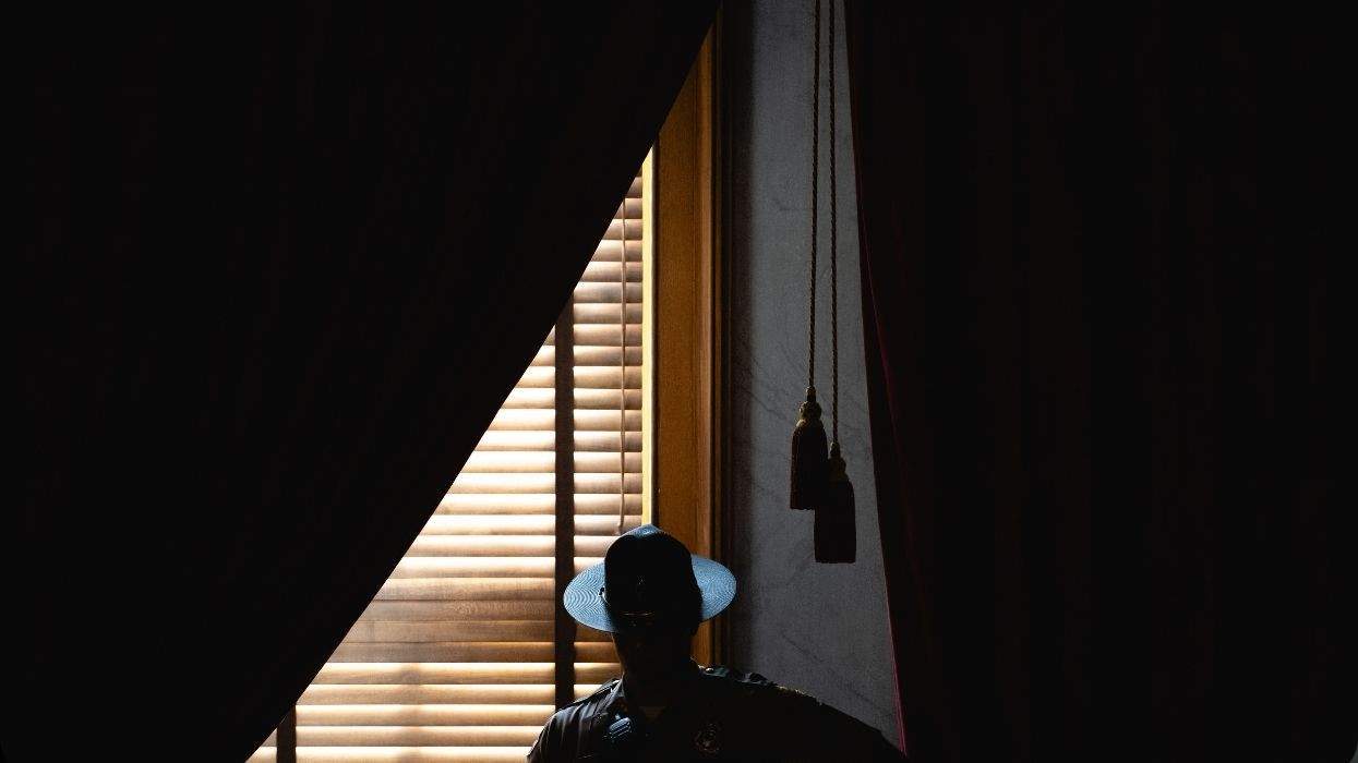 a tennessee state trooper in shadow next to a window