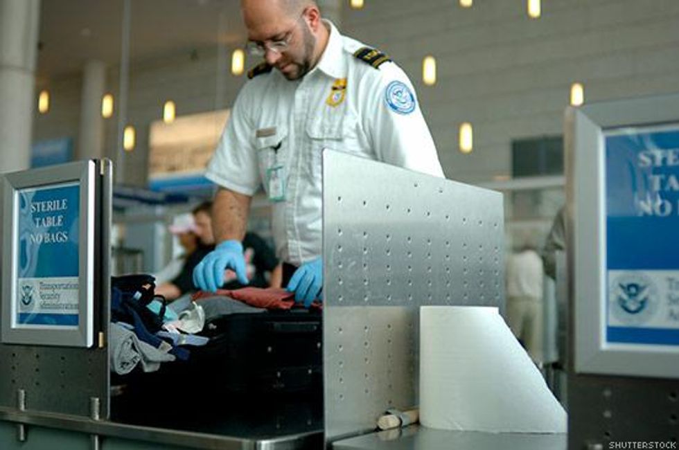 A TSA agent checks luggage