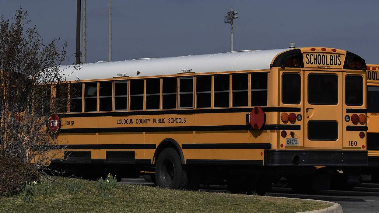A yellow school bus parked in a parking lot reads in black lettering on the side: "Loudoun County Public Schools."