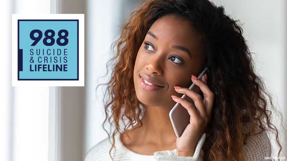 A young woman of color holds a cell phone looking into the distance where the logo for 988 suicide crisis lifeline is superimposed.