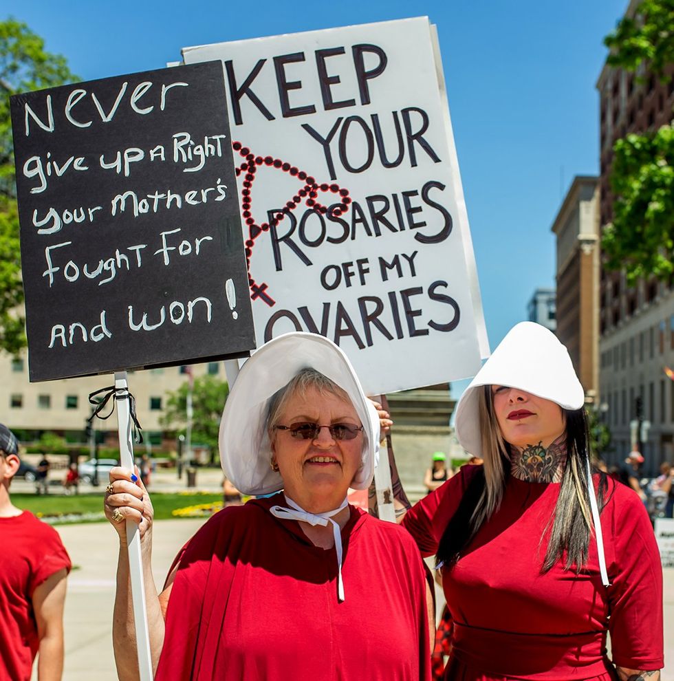 abortion ban fall out protest sign reproductive rights handmaidens lansing michigan