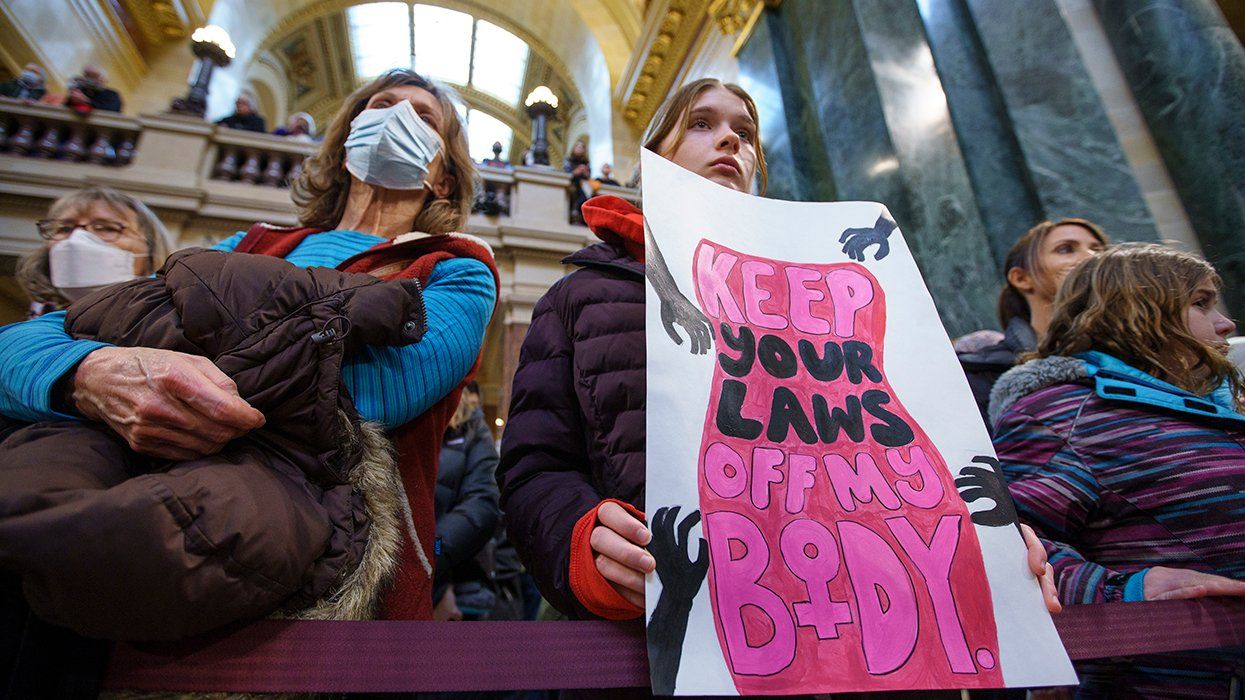 Abortion rights supporters rally at the Bigger Than Roe National Mobilization March in the rotunda of the Capitol building in Madison Wisconsin January 2022