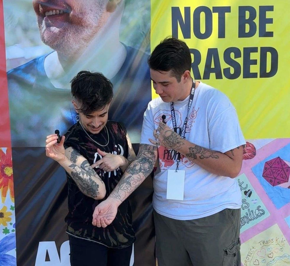 aclu attorney chase strangio and flint del sol are comparing tattoos