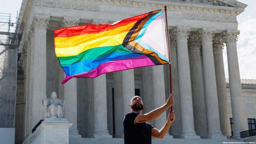 Activist with Pride flag at Supreme Court