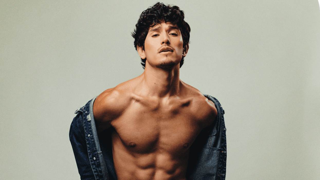 Actor Jacob Martinez posing shirtless with a denim jacket draped off his shoulders in a studio setting