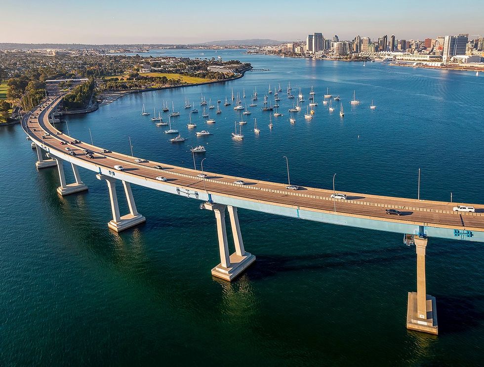 Aerial view of Coronado Bridge in San Diego bay in southern California on a warm sunny day with boats in the bay and cars crossing the bridge
