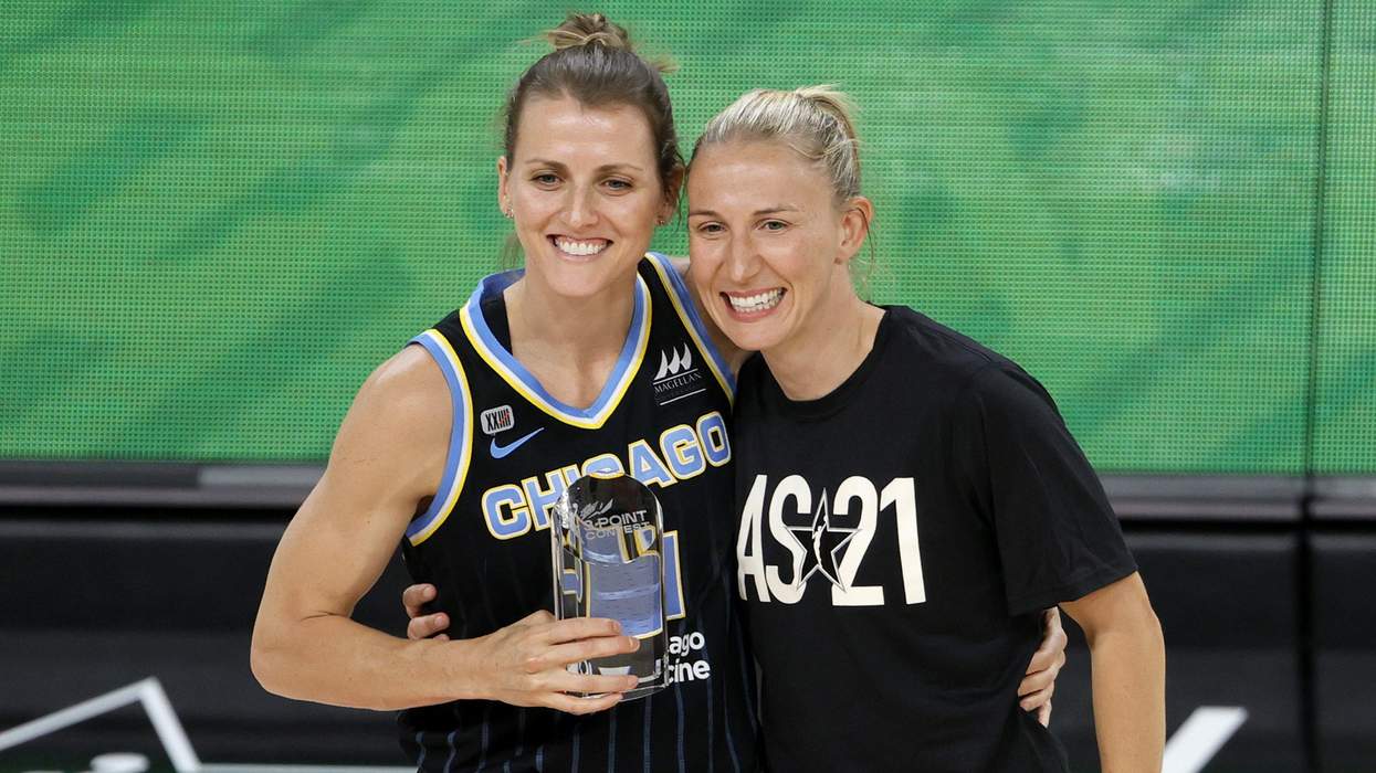 Allie Quigley and Courtney Vandersloot embracing and holding a basketball trophy