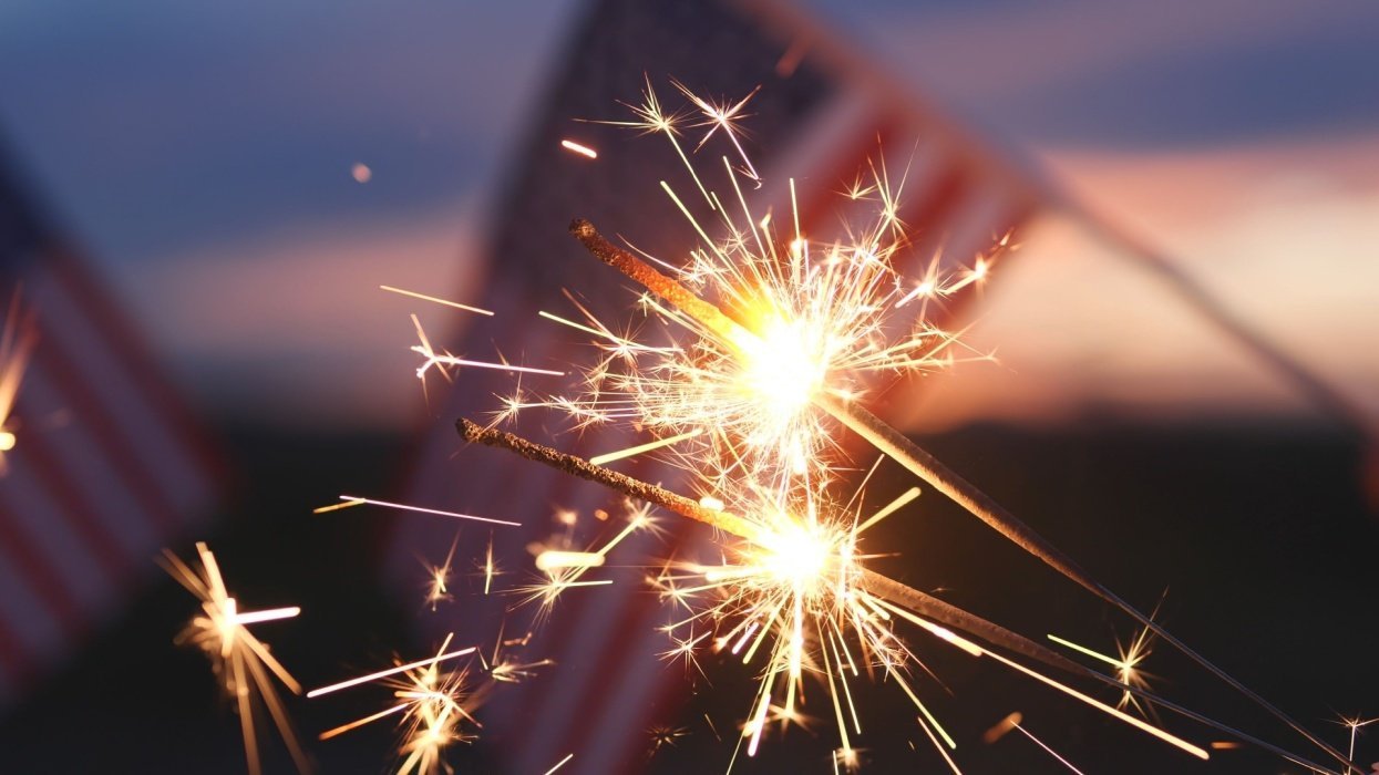 American flags in the background with some sparklers going