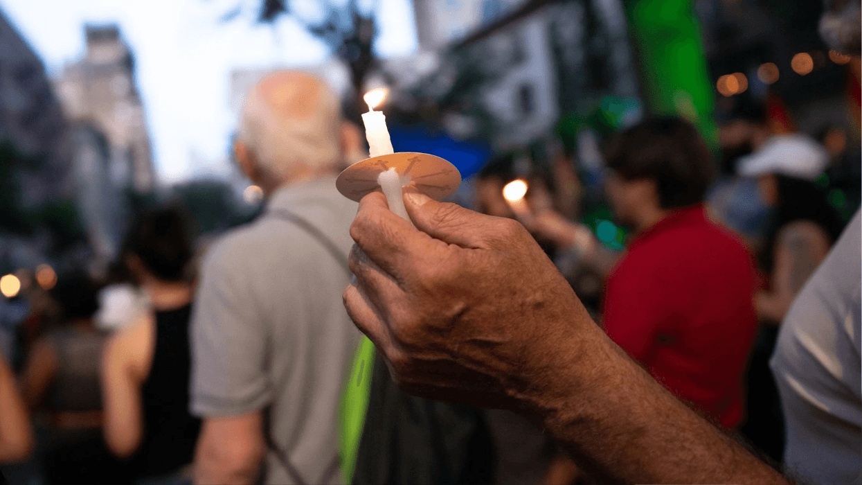 An attendee carries a candle at a New York City AIDS vigil and rally on June 5, 2026.