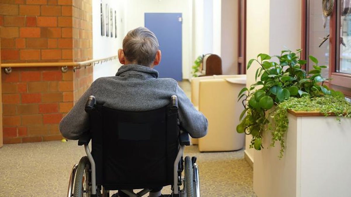 An older adult using a wheelchair
