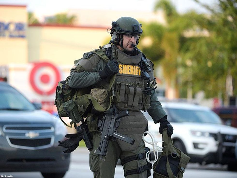 An Orange County Sheriff's Department SWAT member arrives to the scene