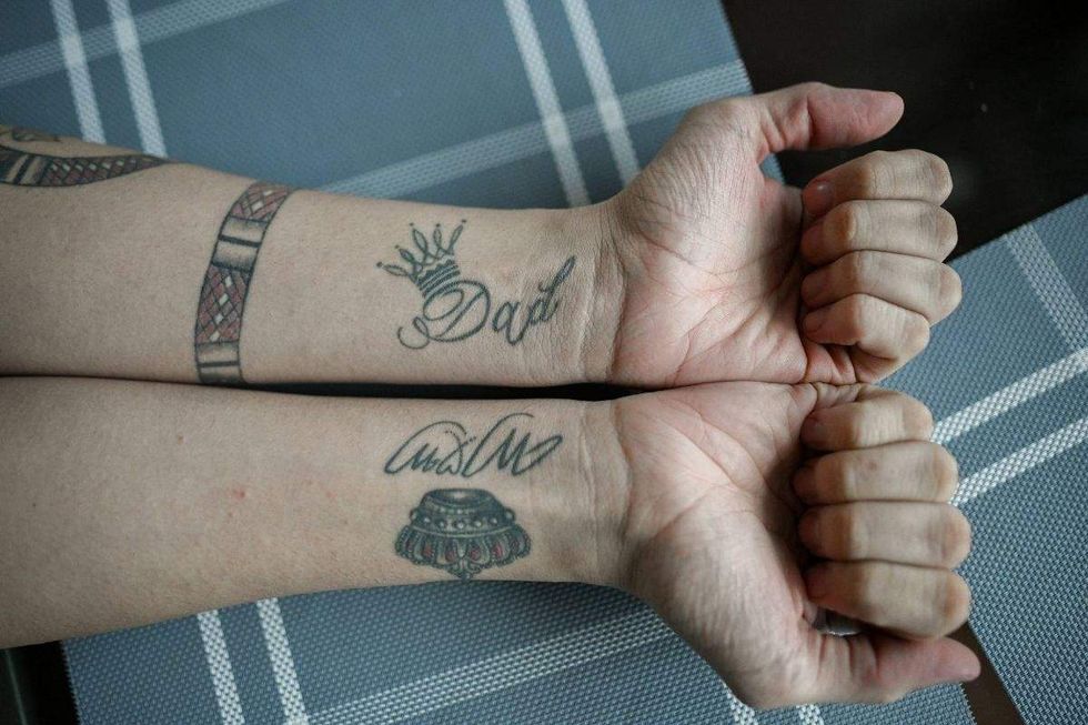 andry hernandez romero's arms with a dad and a mom tattoo with crowns