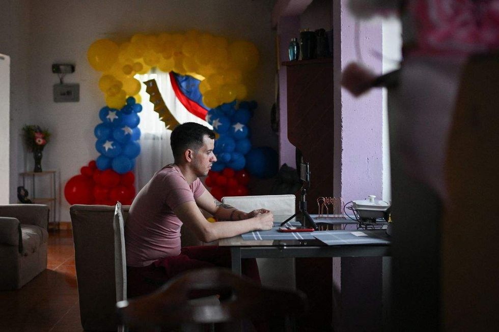 andry hernandez romero sitting at a table