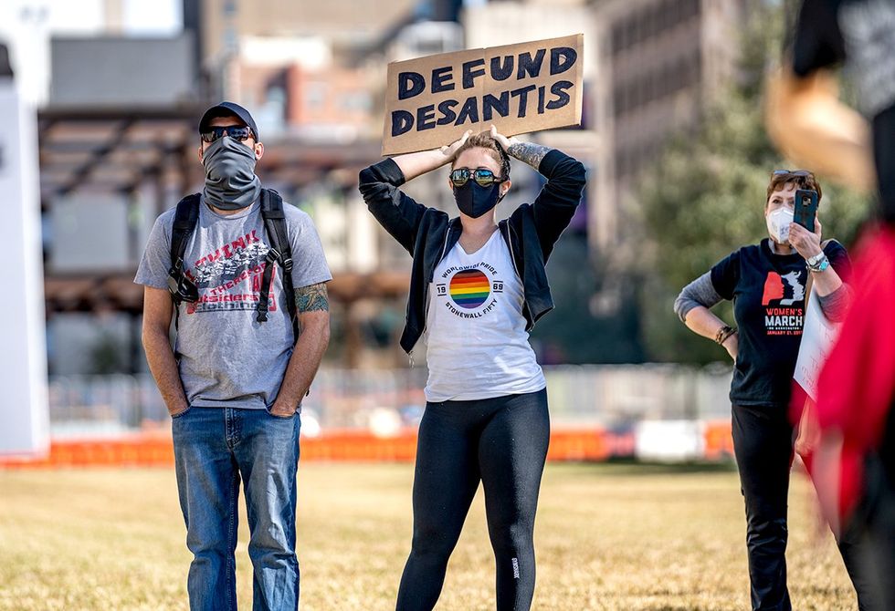 anti LGBTQ agenda negative impact overall health florida defund desantis protest signs