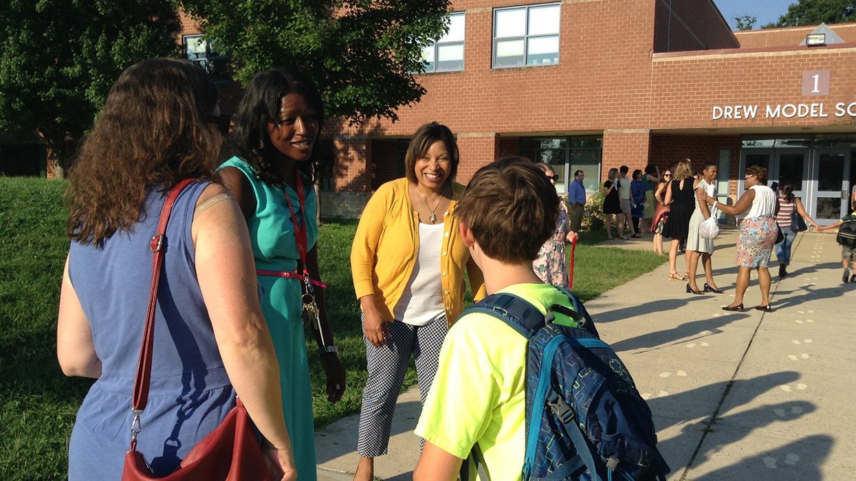 Arlington Public Schools Drew Model entrance principal and teacher speaking to student and parent