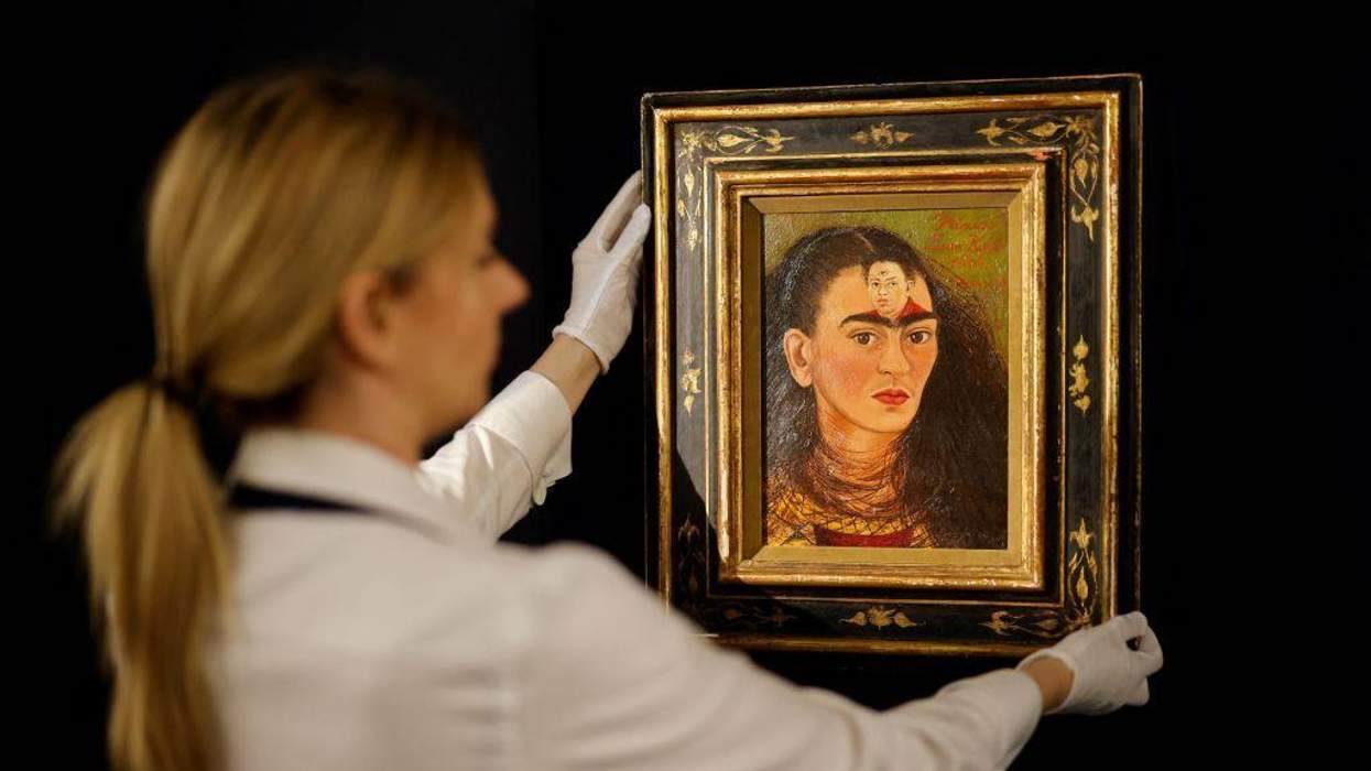 Assistant holding the artwork "Diego and I"